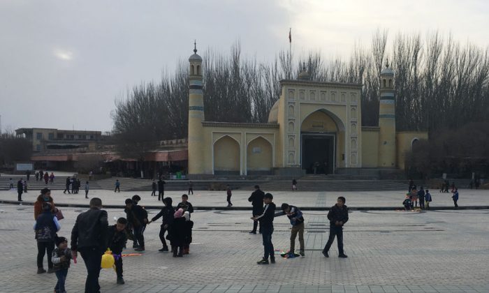Children play outside the Id-kah mosque in Kashgar, in China's western Xinjiang region, on Feb. 18, 2018. (Ben Dooley/AFP/Getty Images)