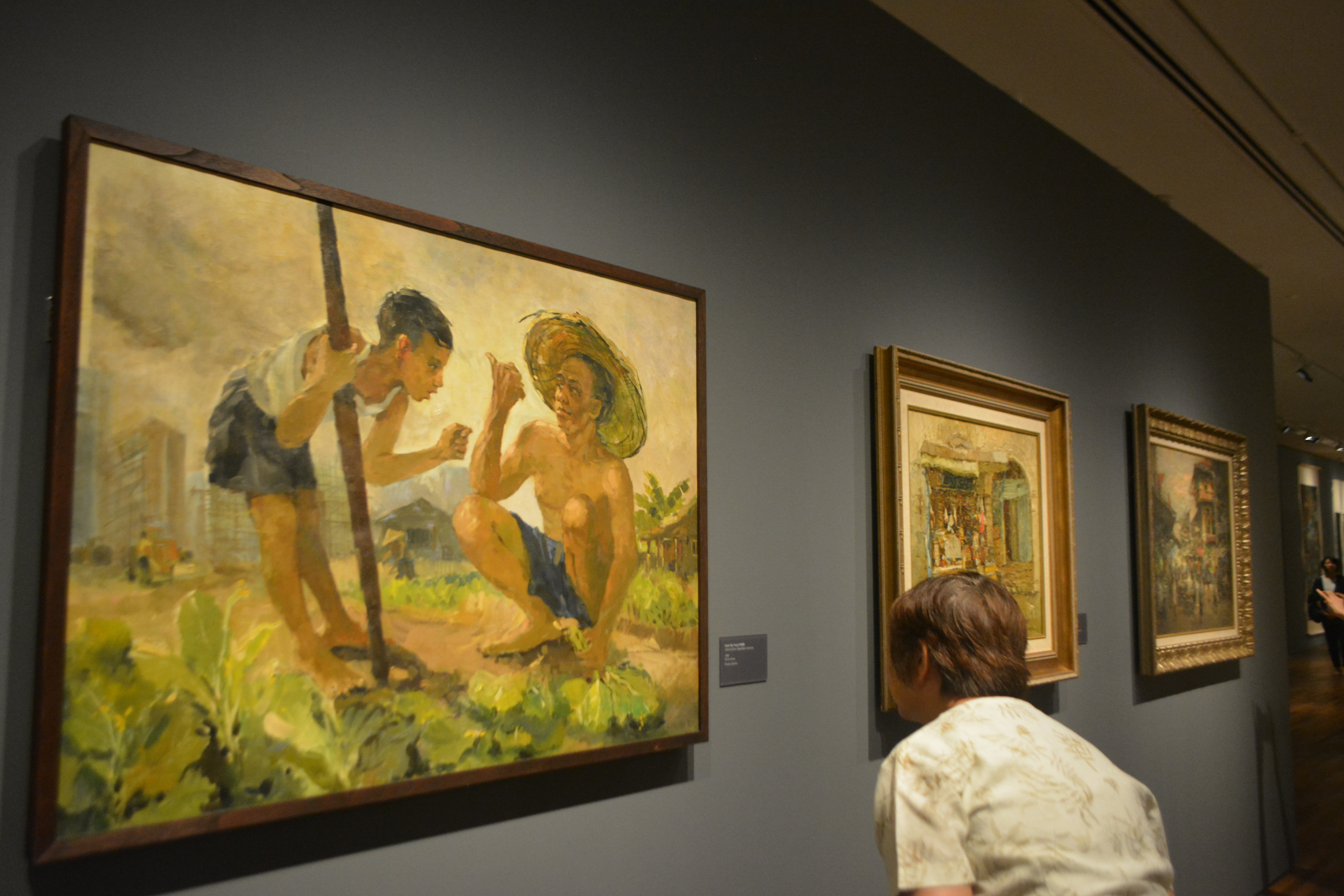 A visitor reads a description of an artist's work inside the newly restored National Gallery in Singapore. (Epoch Times)