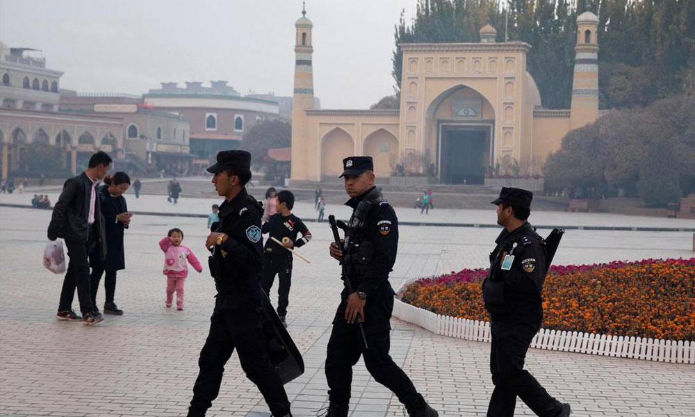 Uyghur security personnel patrol near the Id Kah Mosque in Kashgar, Xinjiang region, China on Nov 4, 2017.
