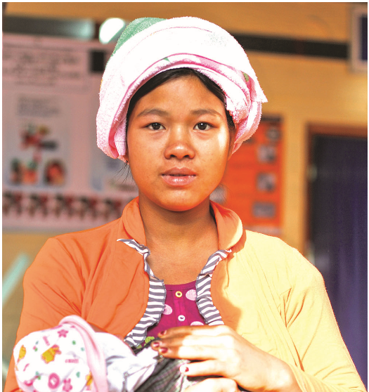 Pearl's image of the mother clad in vibrant orange, holding her newborn, and attending a regular check up at Mawker Thai Clinic , Mae Sot, was published in the 'Medicines for Malaria Ventures Annual Report 2015'.
